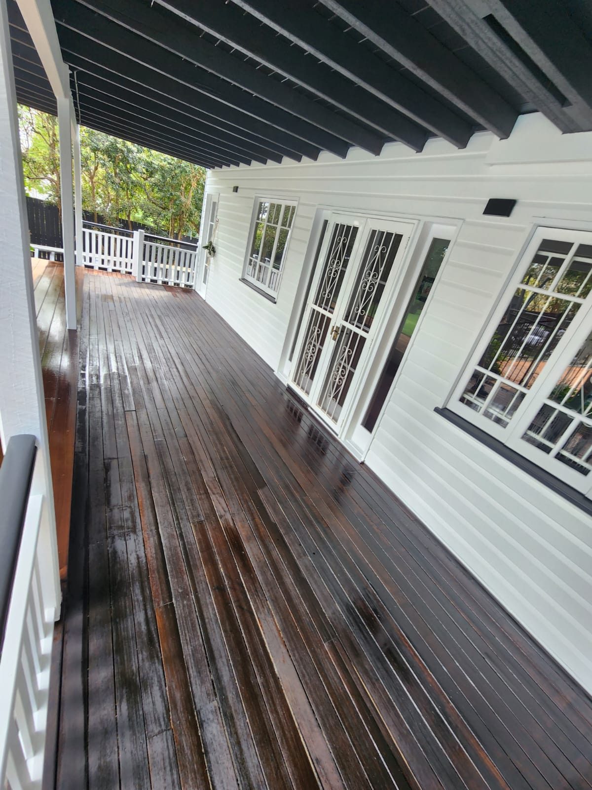Restored timber deck on a white weatherboard home